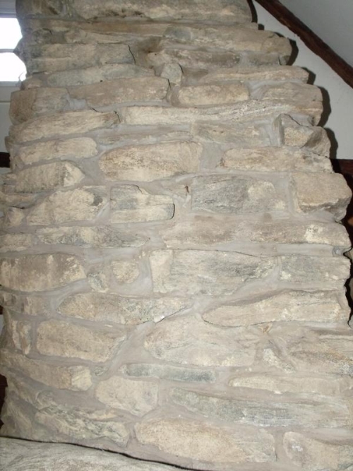 The original chimney in the upper story of the house